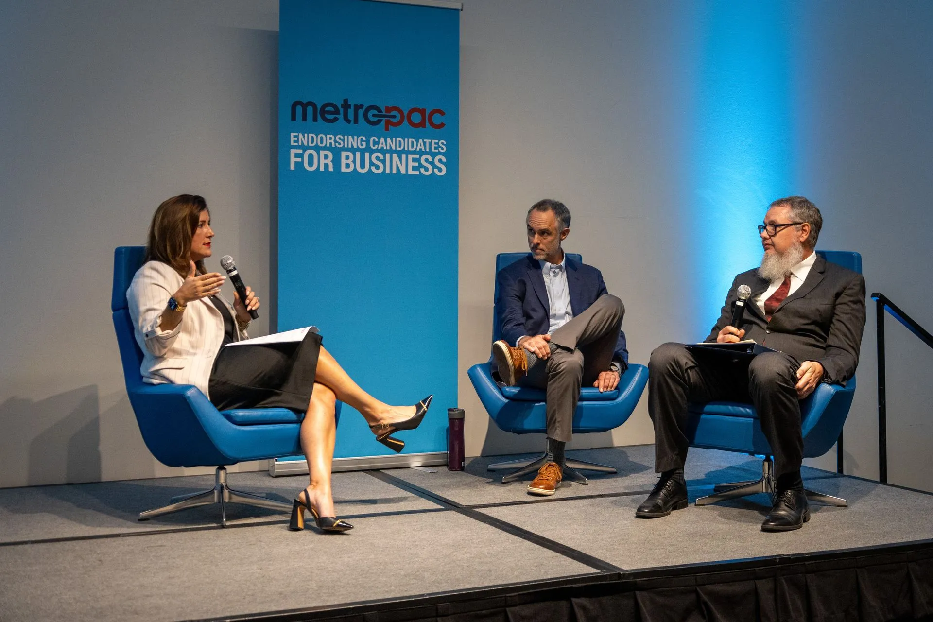 3 people speaking at a conference